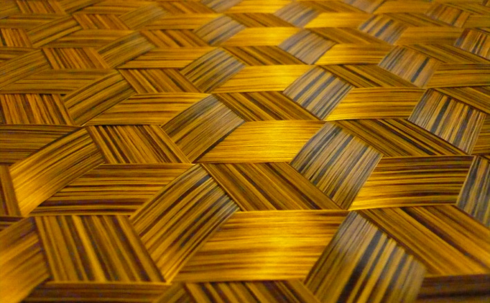 Hybrid triaxial spread tow carbon fiber fabric